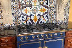 mexican tiles installed on a kitchen backsplash wall